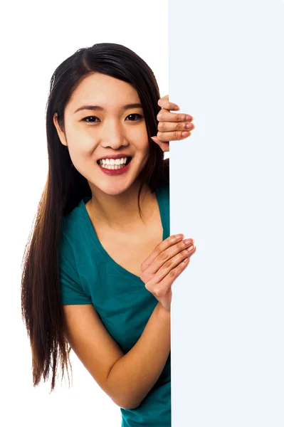 Female model holding blank white ad board — Stock Photo, Image