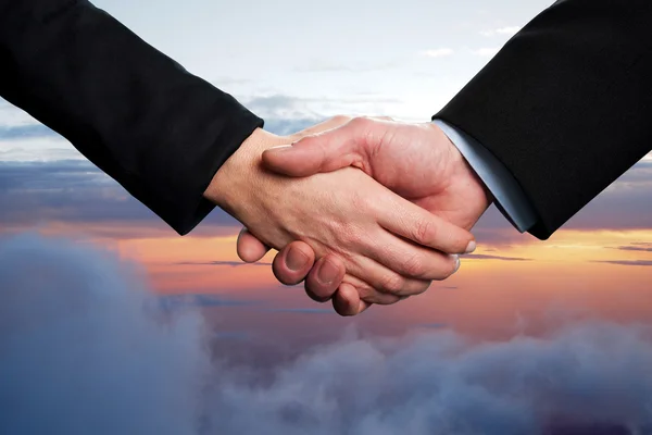 Business handshake on a sky background — Stock Photo, Image