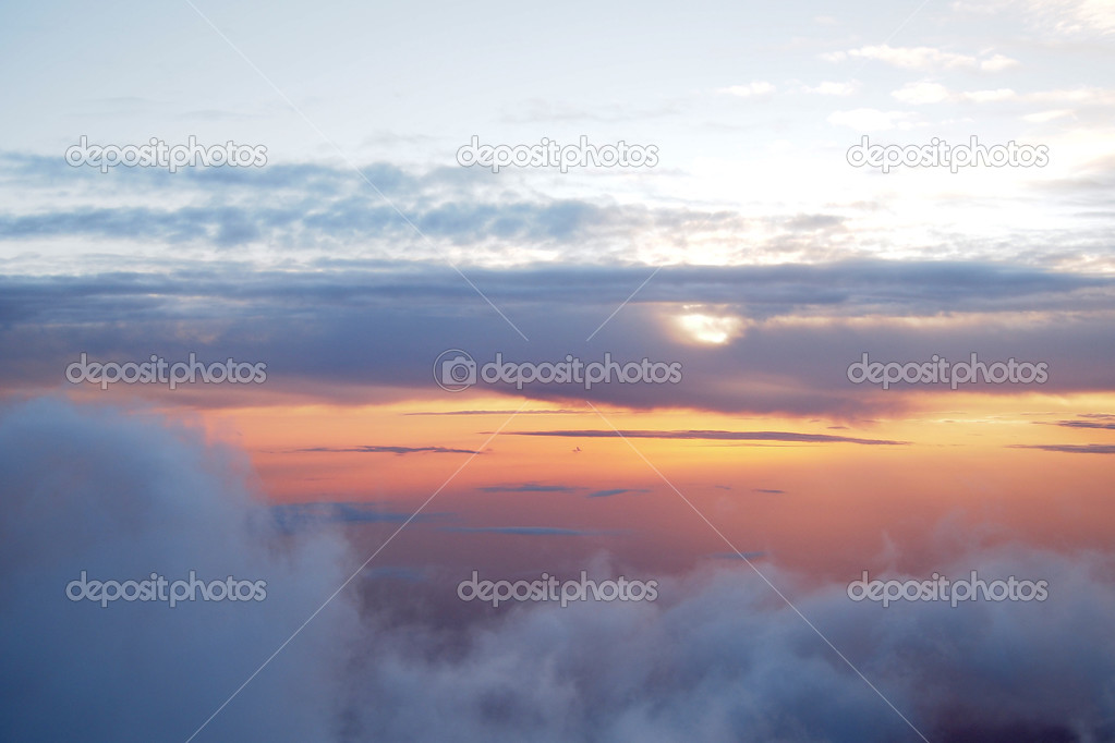 Sunrise above clouds during a flight