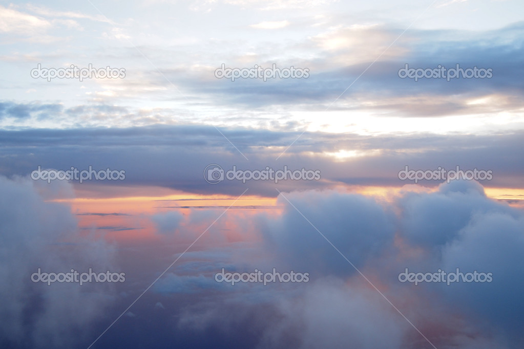 Sunrise above clouds during a flight