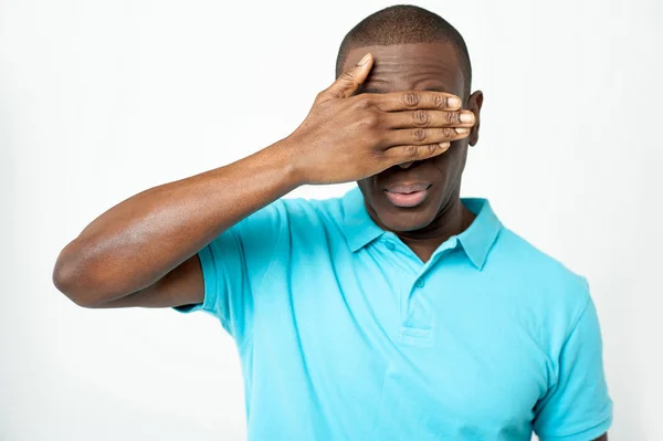 Smart young guy hiding his eyes — Stock Photo, Image