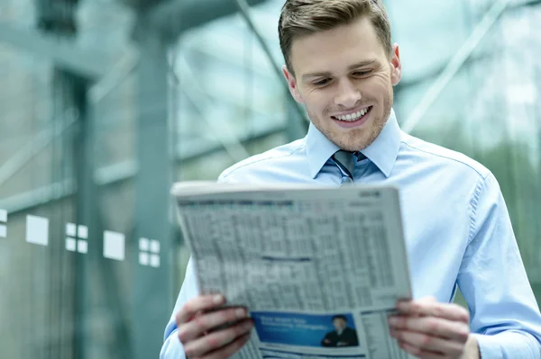 Knappe zakenman lezen van een krant — Stockfoto