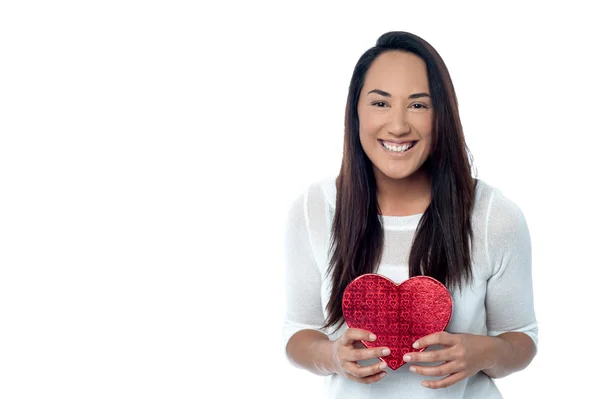 Smiling young woman hold red heart — Stock Photo, Image