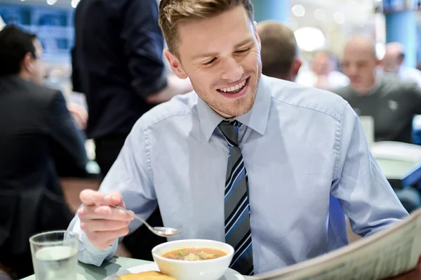 Lachende jonge zakenman in een restaurant — Stockfoto