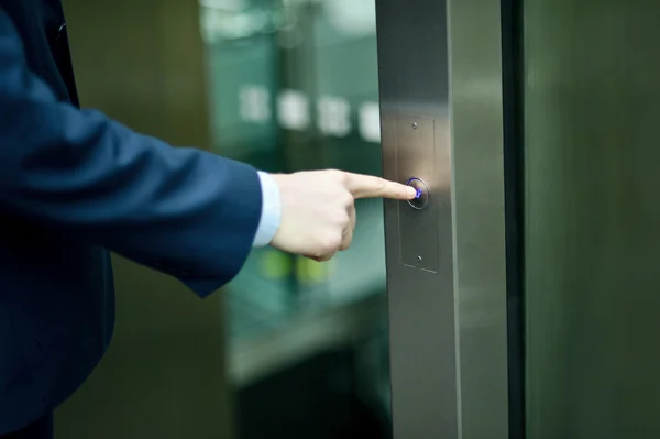 Hand pressing elevator button — Stock Photo, Image