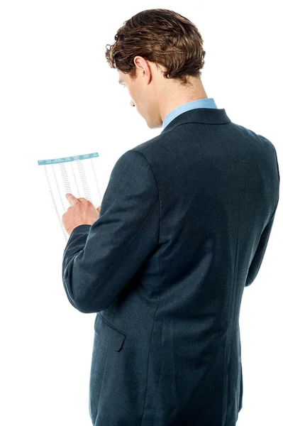 Businessman reviewing business report — Stock Photo, Image