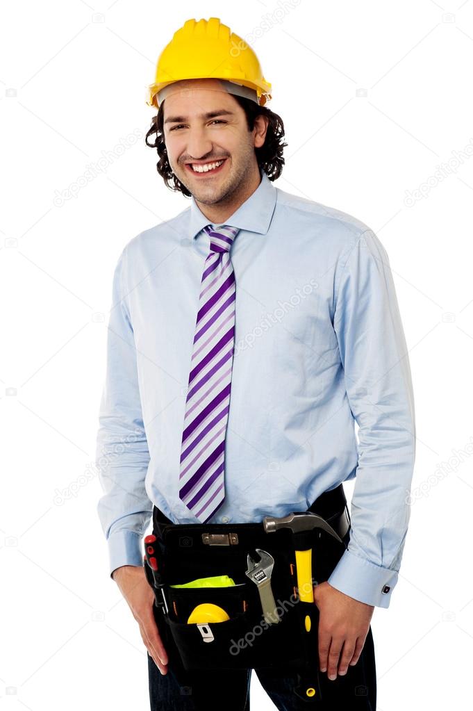 Smiling male architect wearing tool belt
