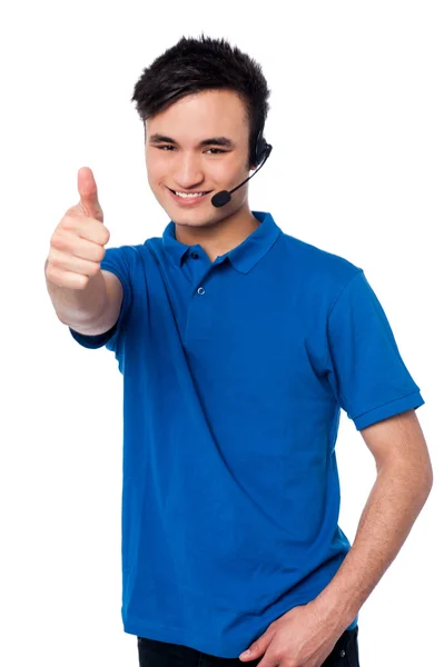 Young man with earphones and thumb up — Stock Photo, Image