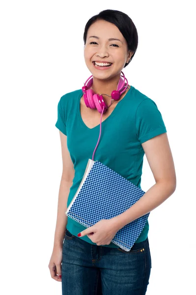 Smiling young student holding notebook — Stock Photo, Image