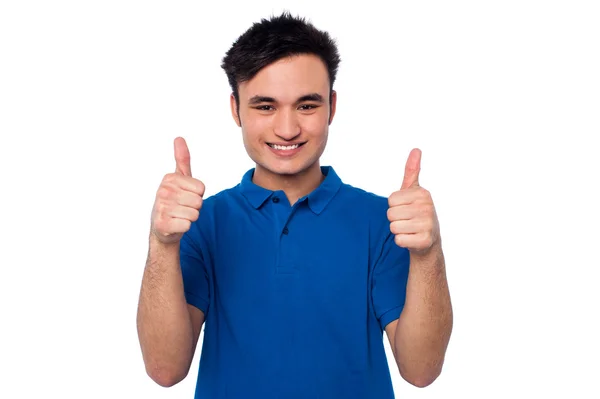 Young casual guy gesturing double thumbs up — Stock Photo, Image