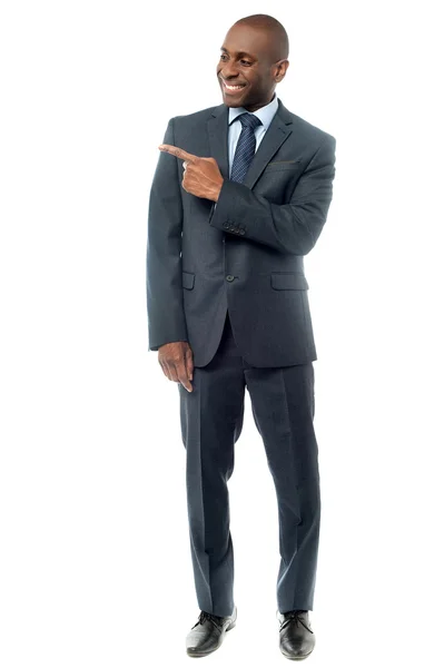 Happy businessman pointing — Stock Photo, Image