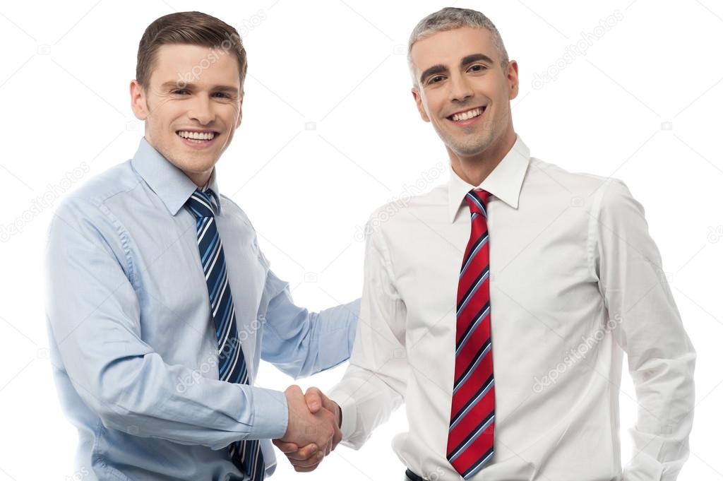 Handsome young executives shaking hands