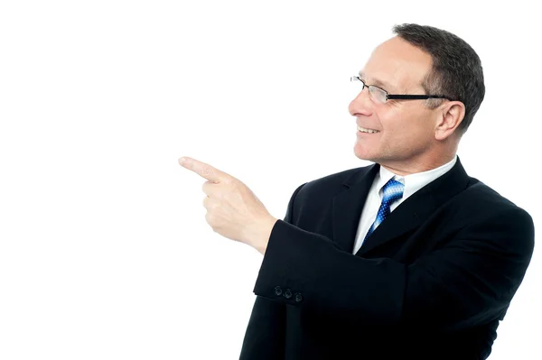 Handsome businessman pointing away — Stock Photo, Image