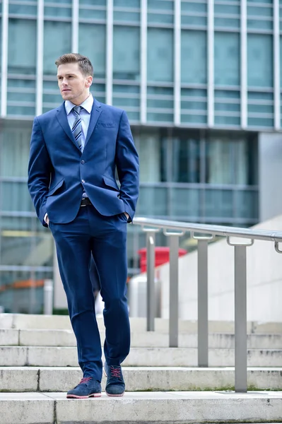 Corporate guy walking down stairs — Stock Photo, Image