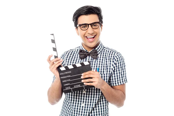 Smiling man holding a movie clap — Stock Photo, Image