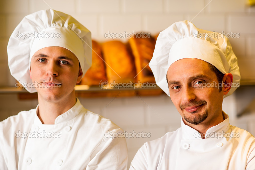 Young smiling chefs posing in bakery