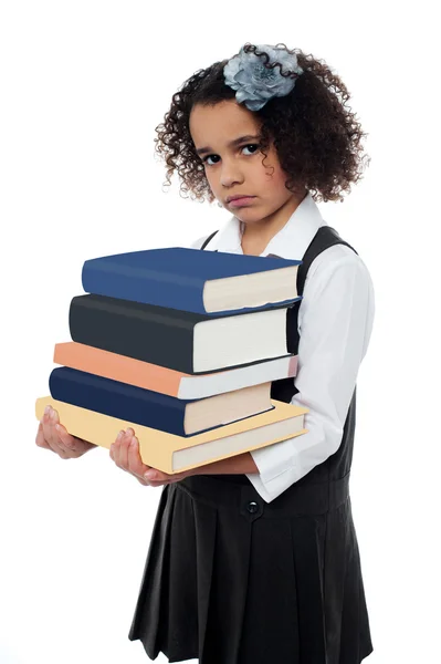 Menina triste segurando pilha de livros — Fotografia de Stock