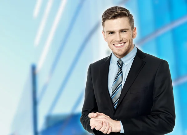 Businessman posing with clasped hands — Stock Photo, Image