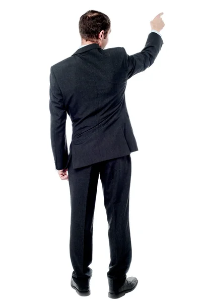 Businessman points finger up — Stock Photo, Image