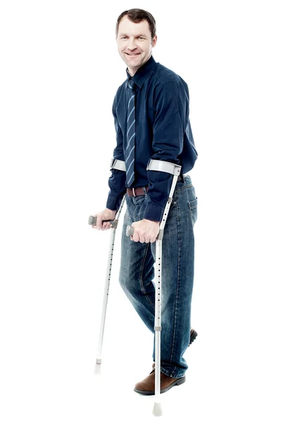 Man with crutches trying to walk — Stock Photo, Image