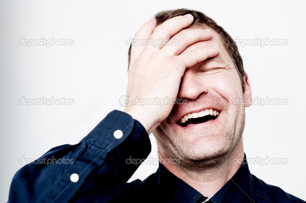 Man laughing with hand on the head