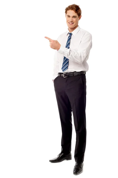 Young business executive pointing away — Stock Photo, Image