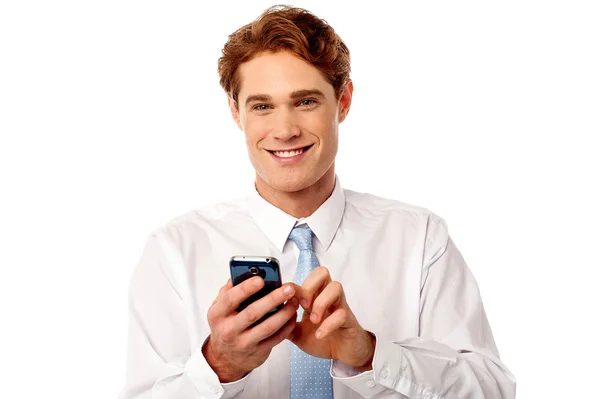 Smiling business executive using mobile phone — Stock Photo, Image