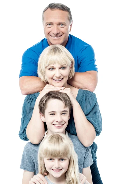 Cheerful family of four standing in a row — Stock Photo, Image