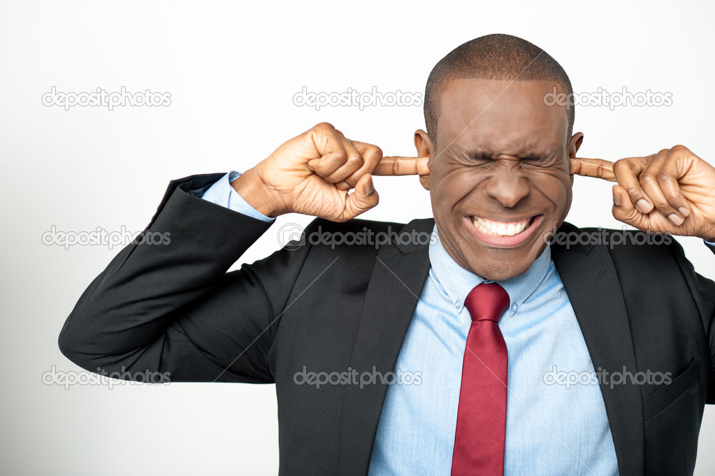 Businessman closing ear by his hands