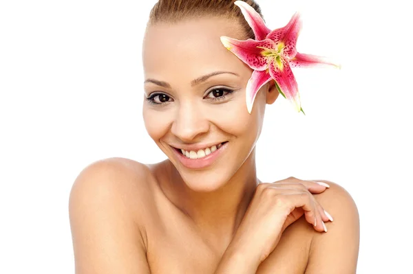 Woman tucked flower behind ear — Stock Photo, Image