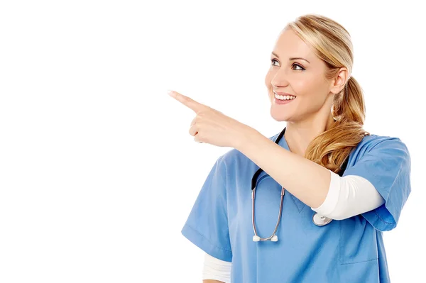 Female physician showing at something — Stock Photo, Image