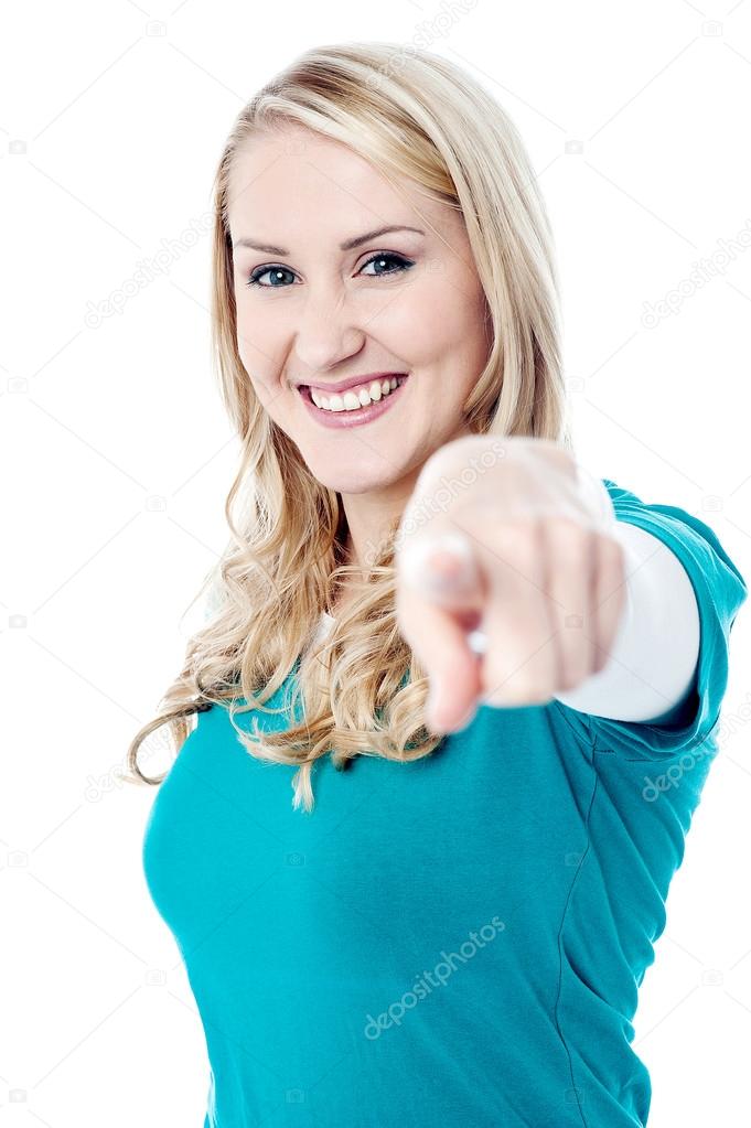 Smiling girl pointing towards camera