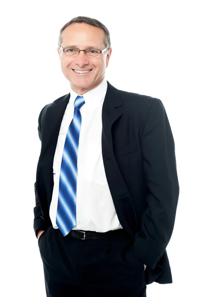 Businessman posing with hands in pockets — Stock Photo, Image