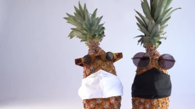 Gözlüklü ve maskeli ananas. Küresel etki kavramı COVID-19.