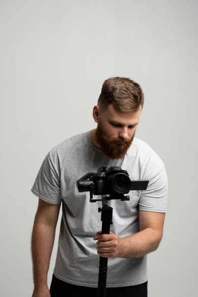 Videographer με μια dslr mirrorless κάμερα που θέτει σε 3-άξονα gimbal. Επαγγελματικός εξοπλισμός βίντεο. Πορτραίτο κινηματογραφιστή. — Φωτογραφία Αρχείου