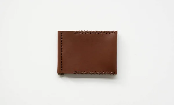 Orange mens money clip handmade leather wallet. Empty money clip wallet with a two pockets for cards lies on a white table. Selective focus, copy space. — Stock Photo, Image