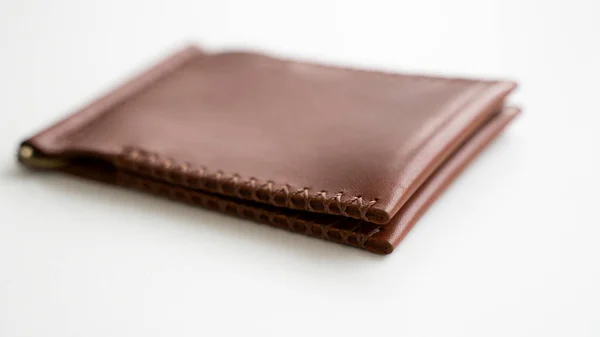 Vazio mens dinheiro clip carteira de couro artesanal com dois bolsos para cartões encontra-se em uma mesa branca. Foco seletivo, espaço de cópia, Fechar. — Fotografia de Stock