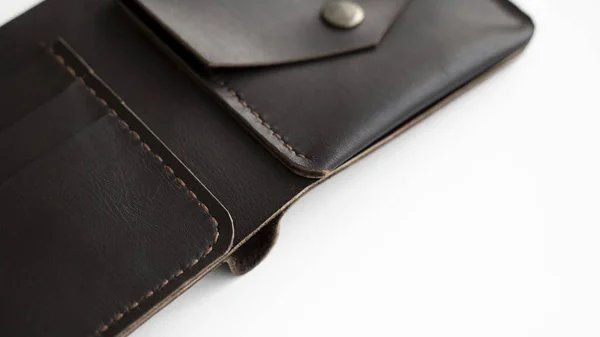 Top view of open brown empty mans black handmade genuine leather wallet with pockets for banknotes, credit cards and monets isolated on white background. Selective focus, copy space, Close up. — Stock Photo, Image