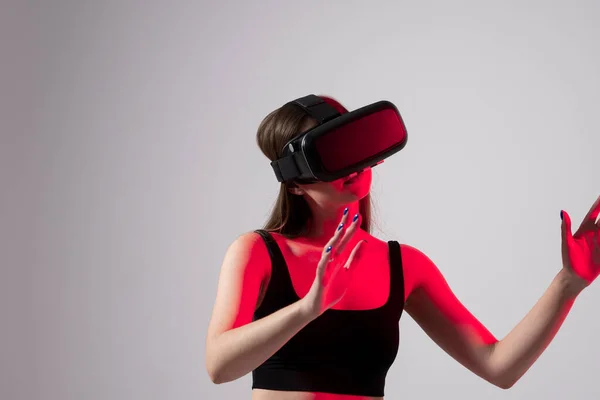 Young woman using virtual reality headset and touching virtual objects. VR, future, gadgets, technology, education online, studying, video game concept