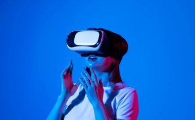 Close up of woman engineer, architector in vr headset working with engineering project in studio
