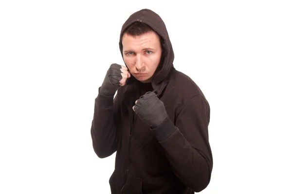 Young man in a hoodie standing in a fighting stance — Stock Photo, Image