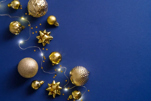 Blue Christmas background with golden decorations, balls, lights. Merry Christmas or Happy New Year concept.