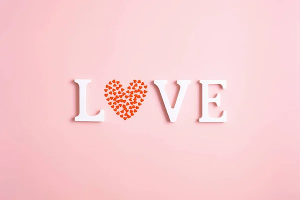 Word Love Made White Letters Heart Shaped Confetti Pink Background — Stockfoto