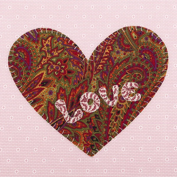 Handmade fabric heart with the word love — Stock Photo, Image