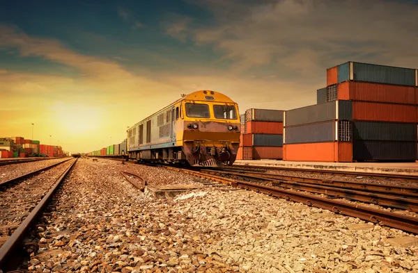 Вантажна залізнична платформа на заході сонця з контейнером — стокове фото
