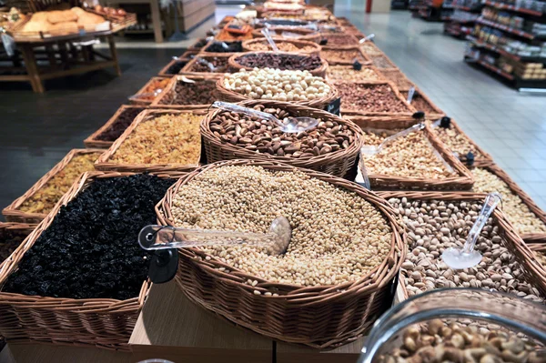 Various dried fruits and nuts in market — Stock Photo, Image