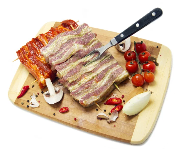 Fresh pork meat with a bone on a wooden cutting board, isolated — Stock Photo, Image