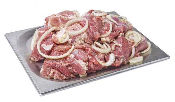 Raw meat with onion rings for a kebab in a metal plate — Stock Photo, Image