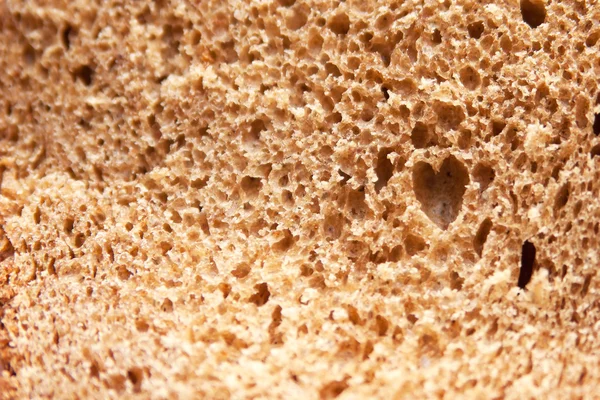 Cut piece of dark bread — Stock Photo, Image
