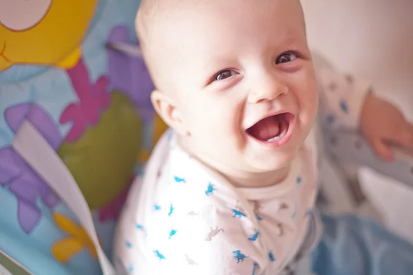 Laughing baby showing first milk tooth — Stock Photo, Image